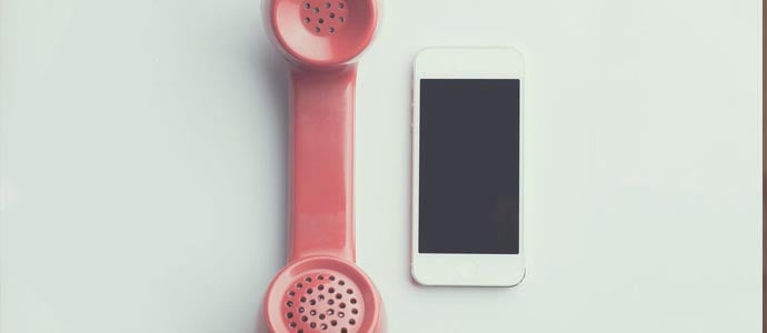 retro telephone next to an iphone 