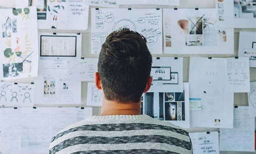 guy with lots of ideas on a pin board